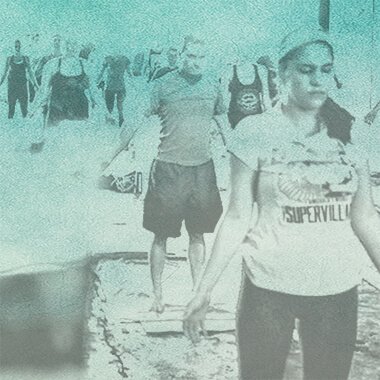 Group of people walking outdoors, some wearing masks, with a mural or graffiti wall in the background.