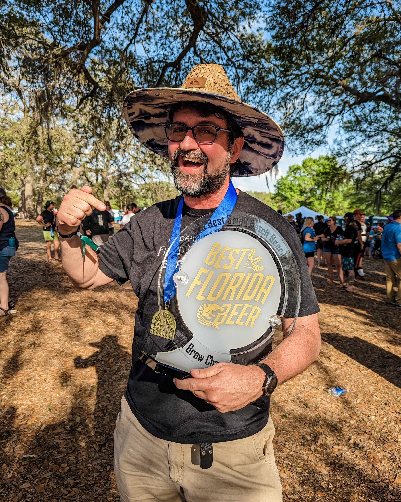 John holding best small batch beer trophy wearing a medal