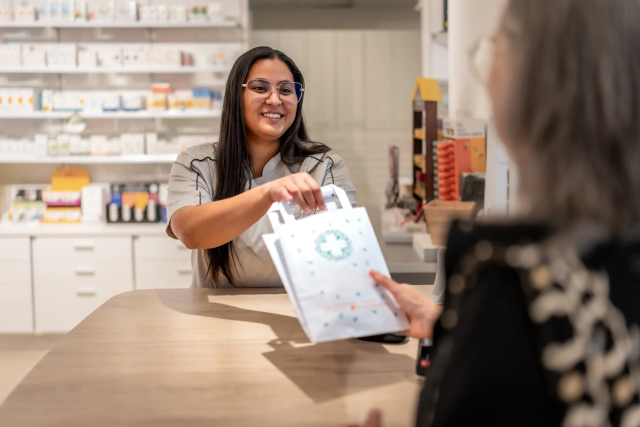 Pharmacist handing prescription