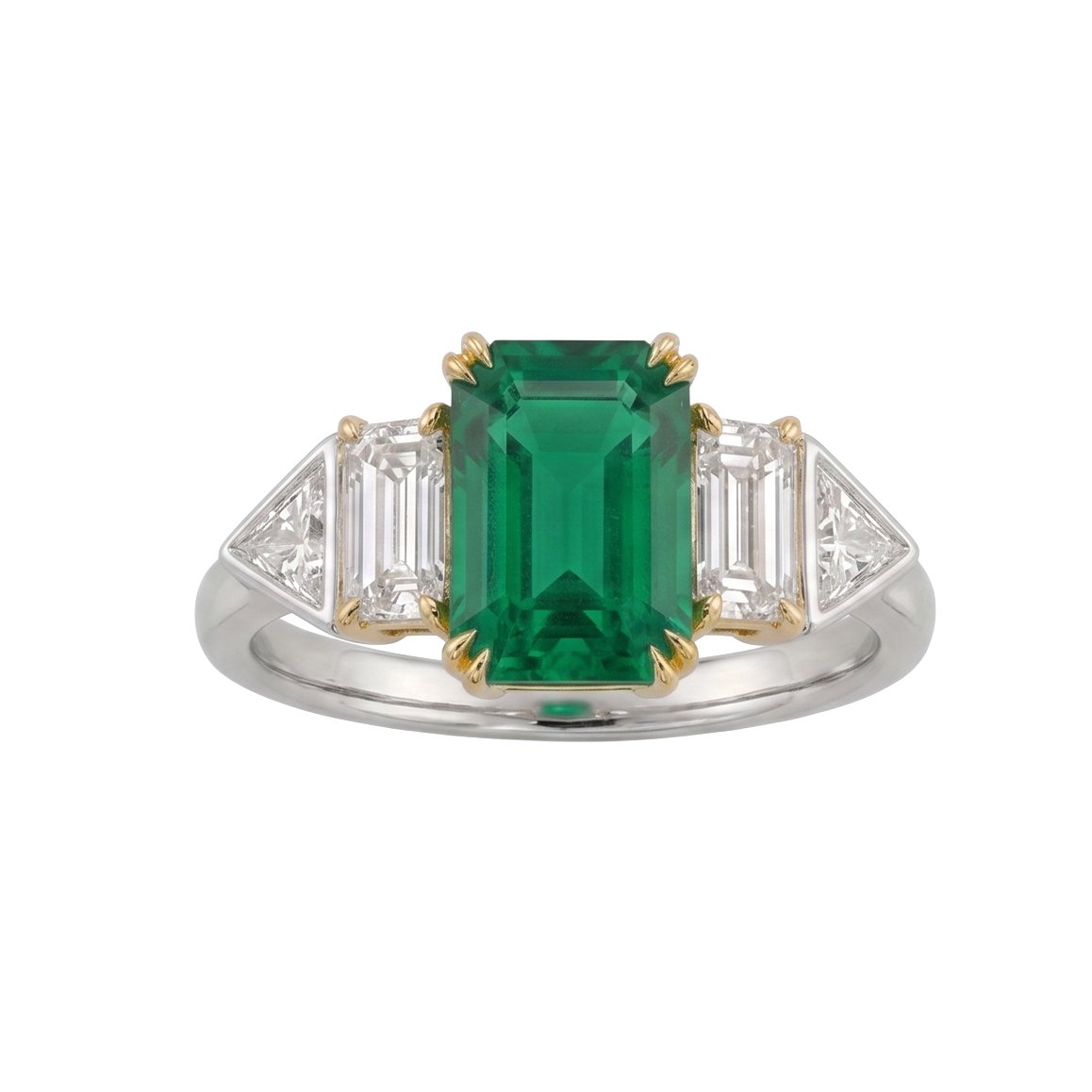 Elegant ring featuring a large emerald center stone flanked by two trapezoid-shaped diamonds set in a two-tone band.