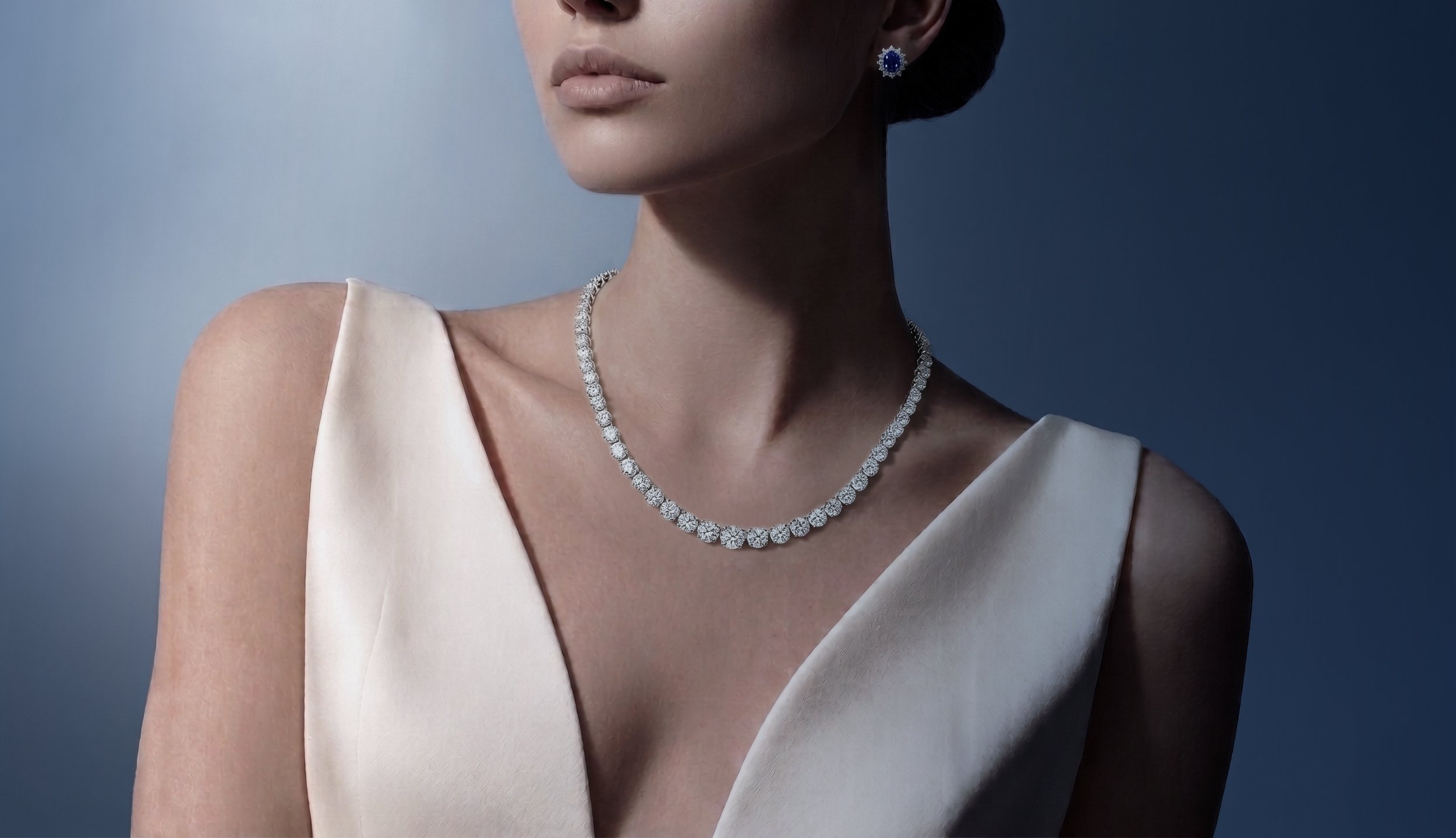 a photo of a woman wearing a platinum and diamond necklace is wearing a white sleeveless dress
