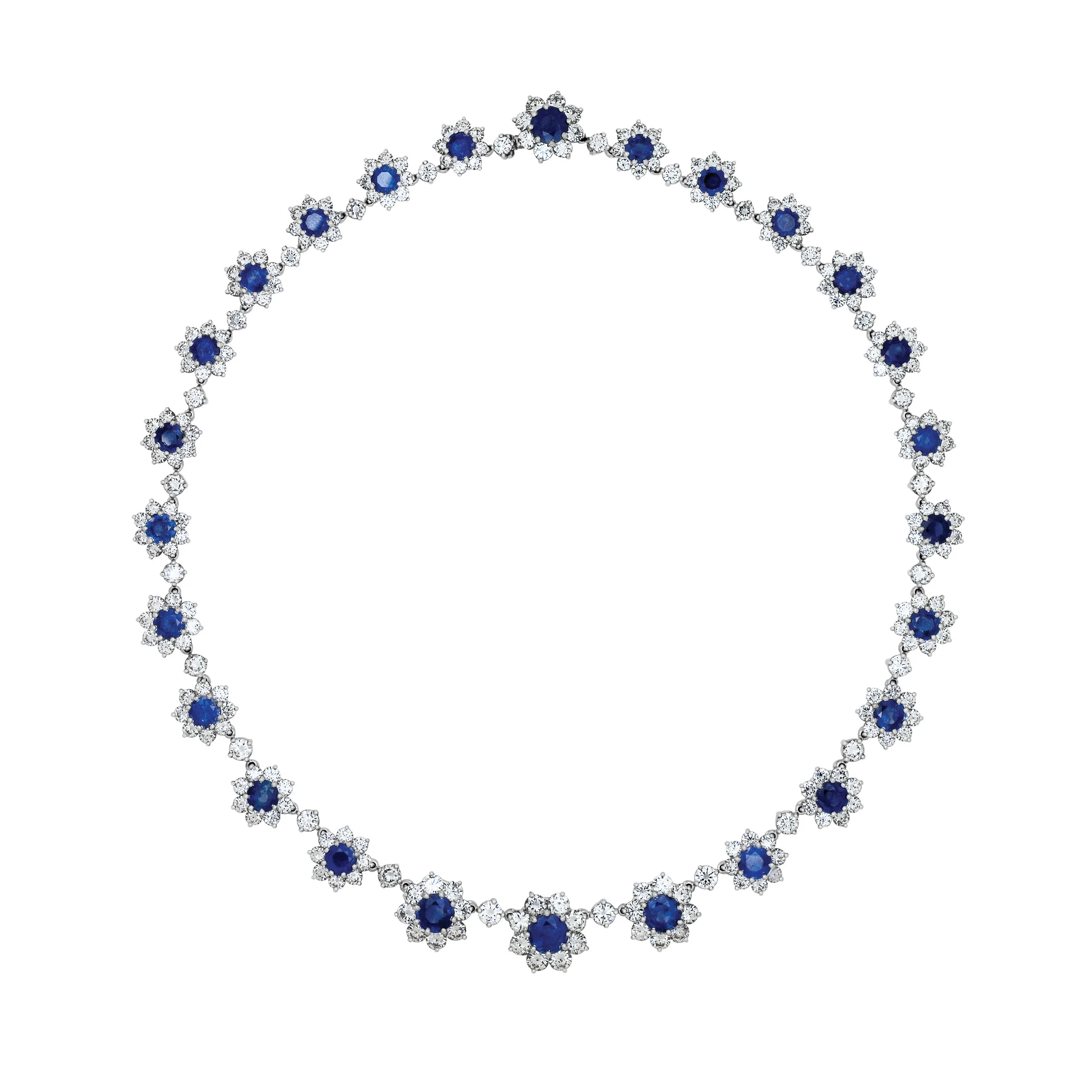 Jewelry set with a necklace and matching earrings featuring blue gemstones surrounded by small white stones on a white background.