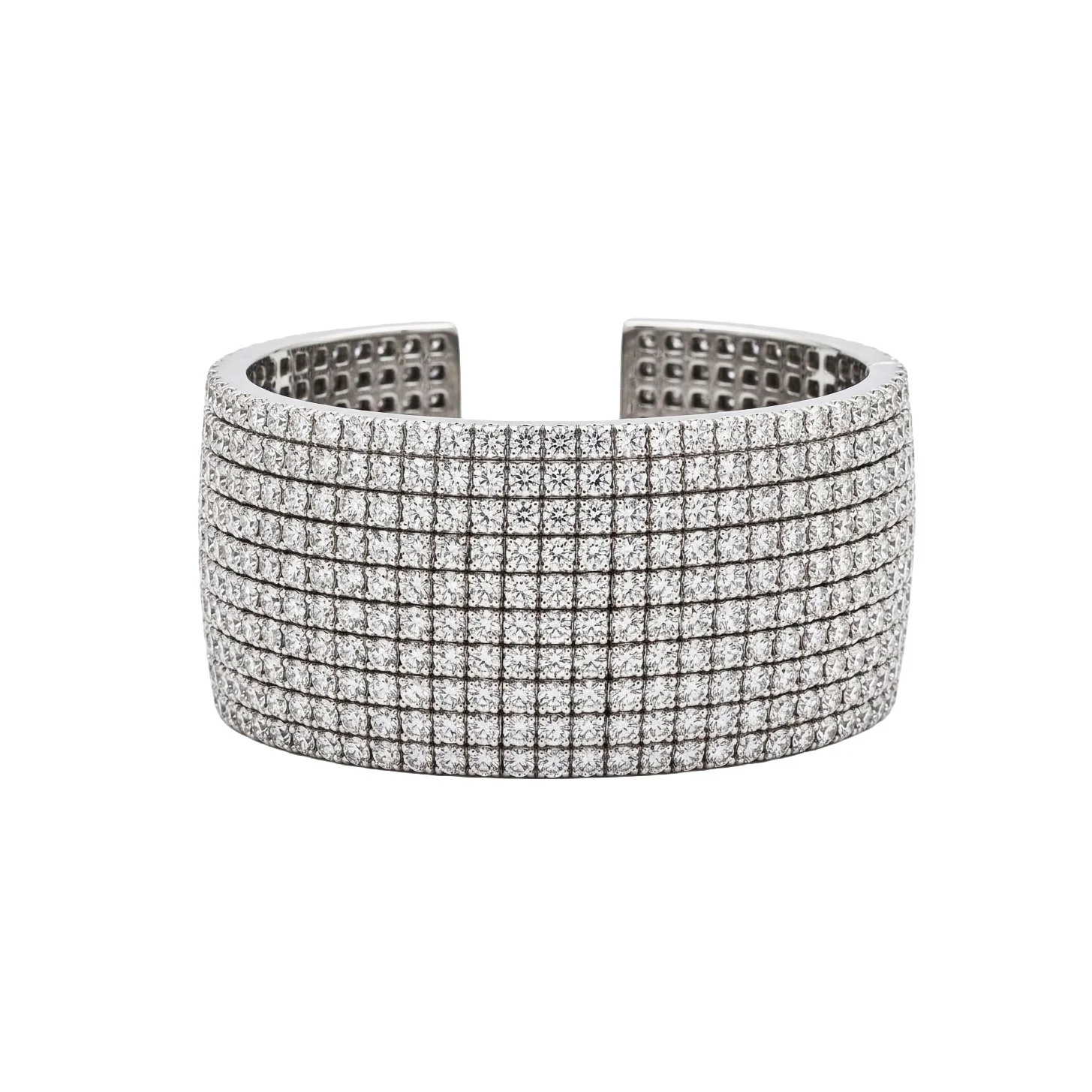 A wide silver cuff bracelet encrusted with multiple rows of small clear diamonds.