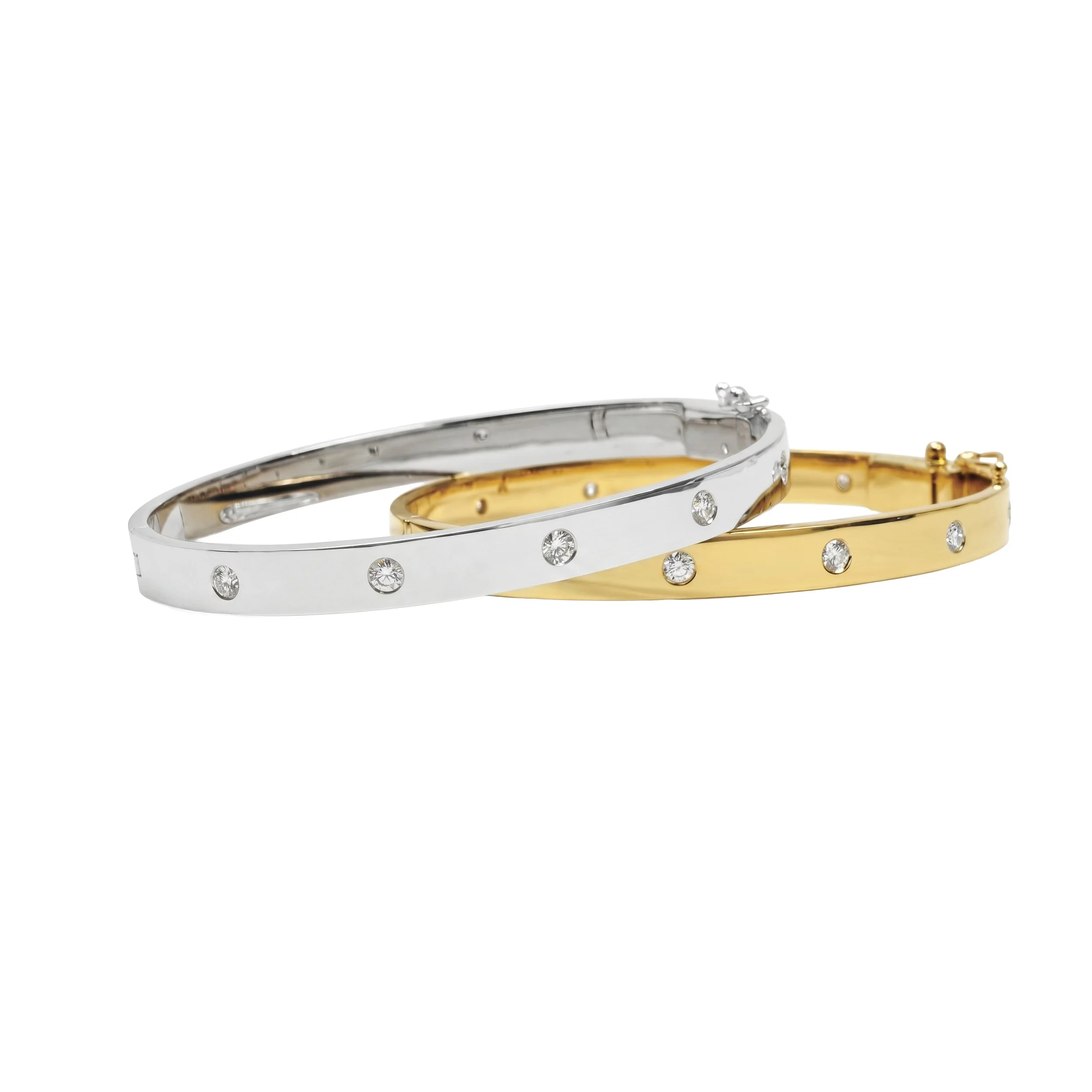 Close-up of two intertwined rings, one silver with embedded diamonds and one gold, on a white background.