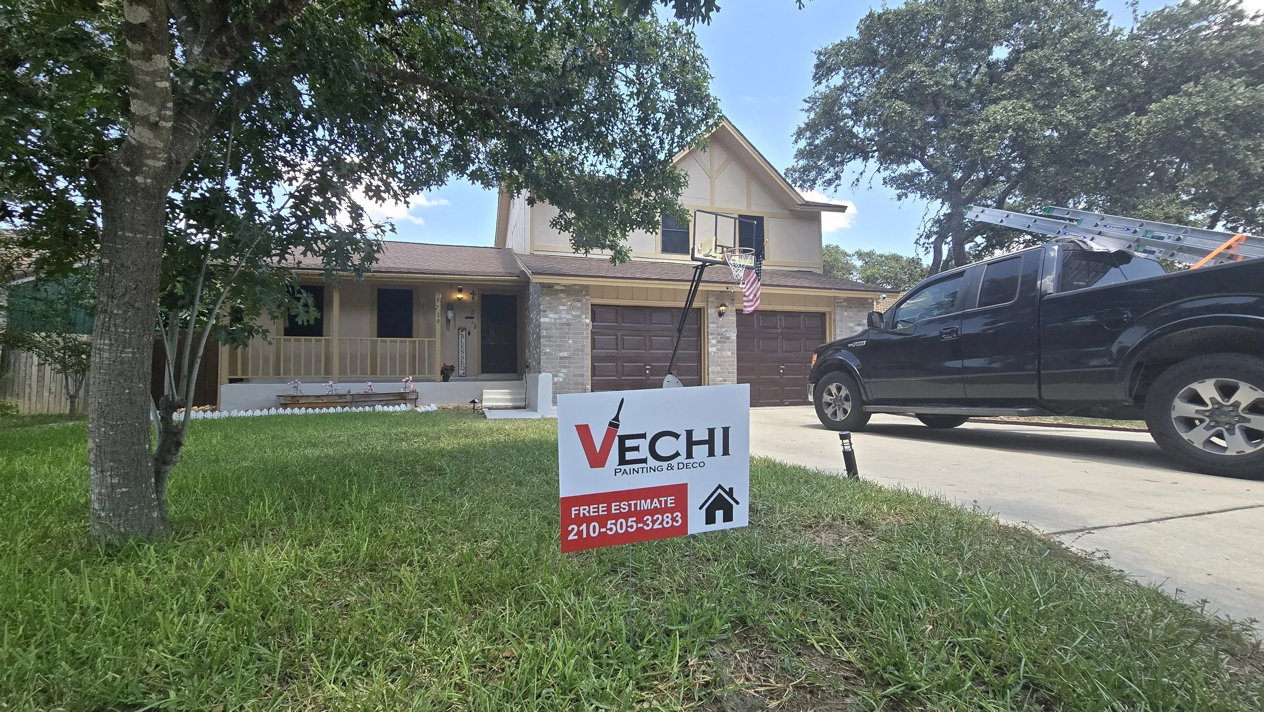 Front yard of a house with a sign for VeCHI Painting & Deco offering a free estimate with phone number, a black truck with a ladder parked in driveway, and a basketball hoop in the yard."}#seotools