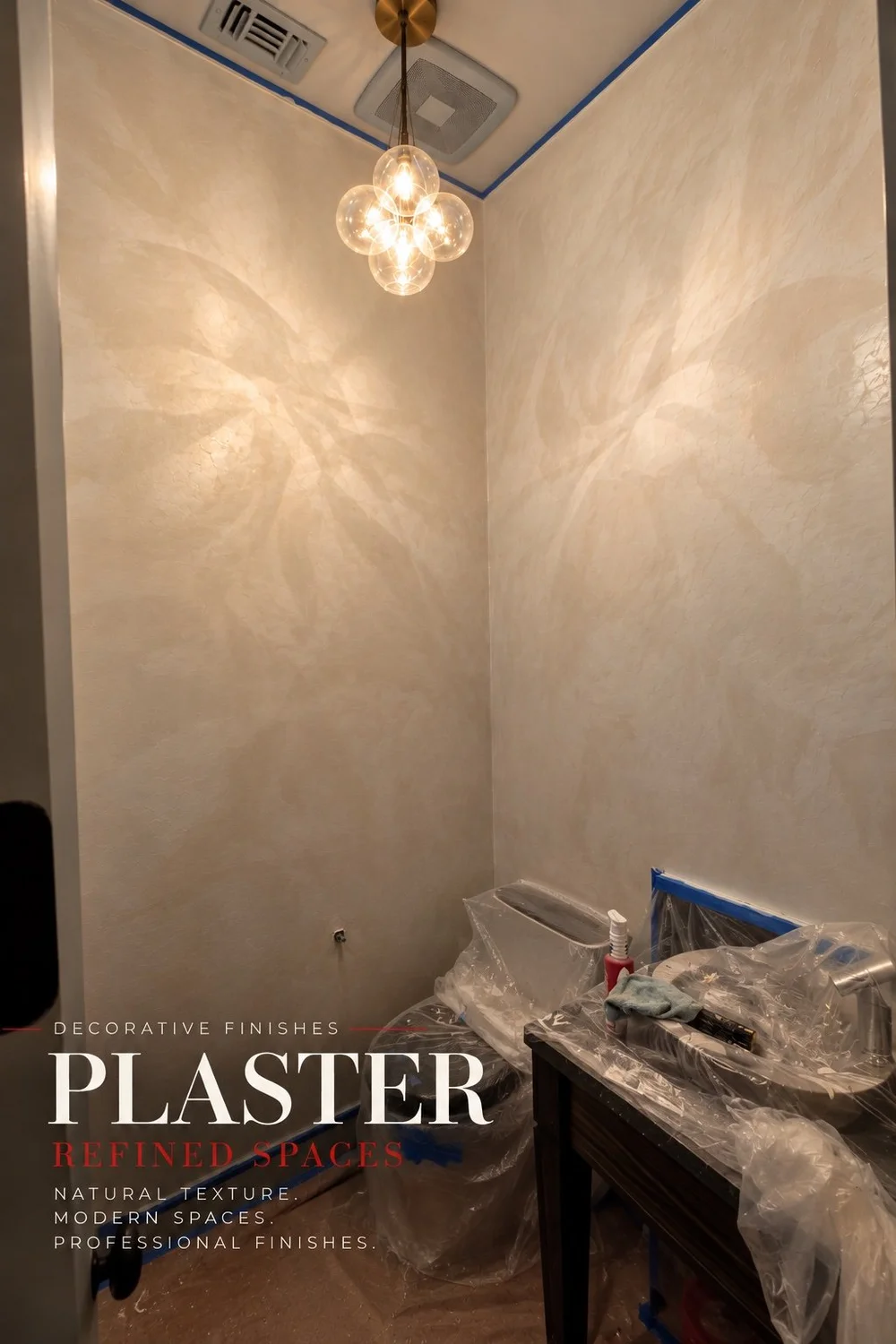 Decorative plaster bathroom walls during the finishing process, with protected fixtures — EST Painting.