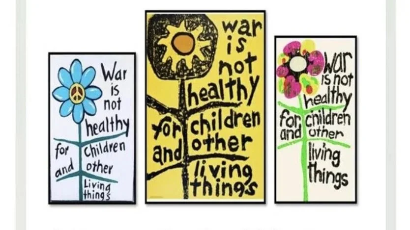 Three children's drawings with flowers and peaceful symbols, each with the message "War is not healthy for children and other living things" written on them.