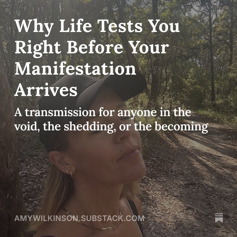 A woman outdoors in a wooded area, wearing a gray cap and a necklace, with the sun shining through the trees. Overlaid text reads: "Why Life Tests You Right Before Your Manifestation Arrives. A transmission for anyone in the void, the shedding, or the becoming."