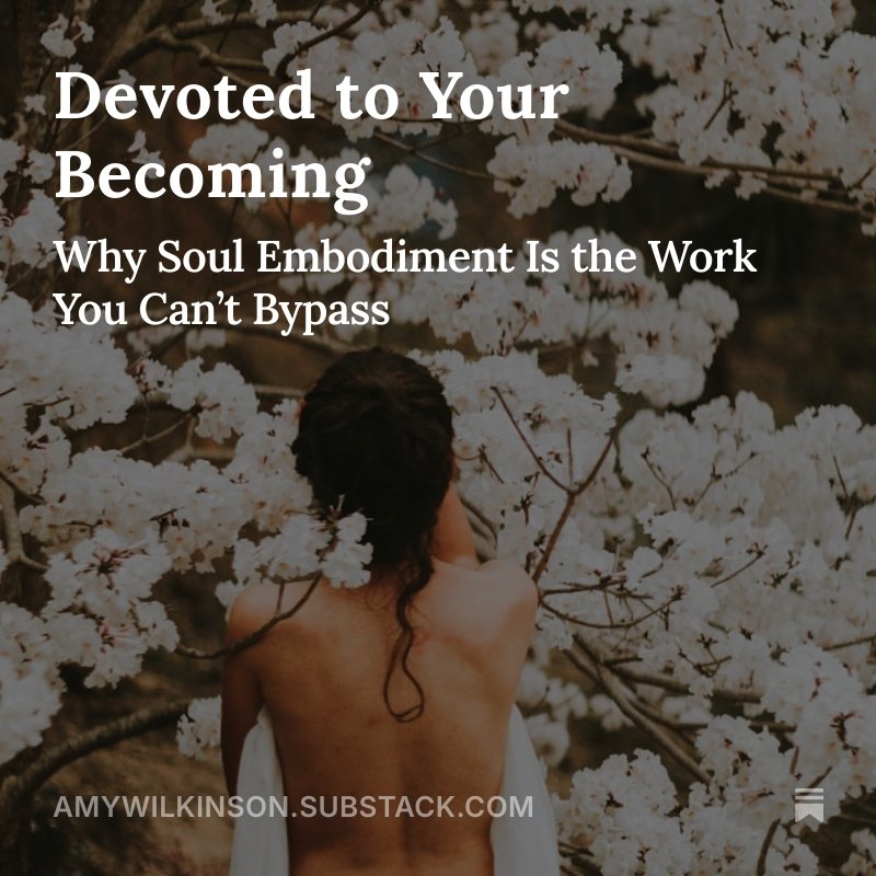 Woman with dark hair and bare back standing among blooming white cherry blossom trees.