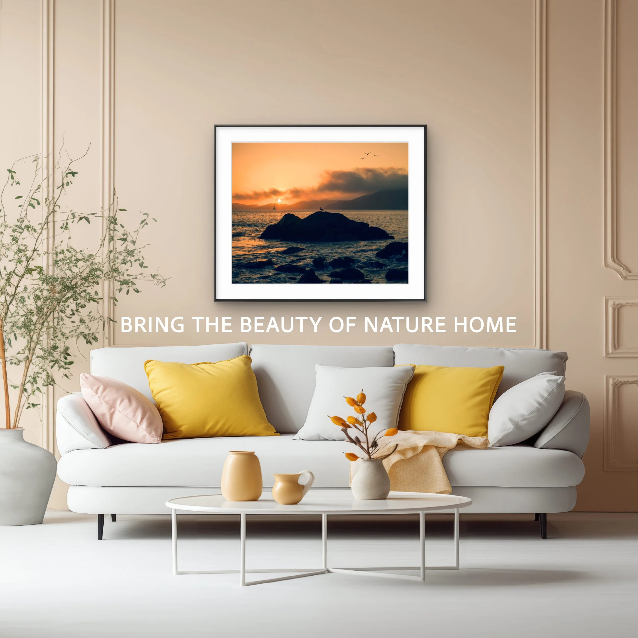 Living room with a white sofa, yellow and pink pillows, a glass coffee table with beige vases and a plant, a framed sunset photograph on the wall, and the caption 'Bring the beauty of nature home'.