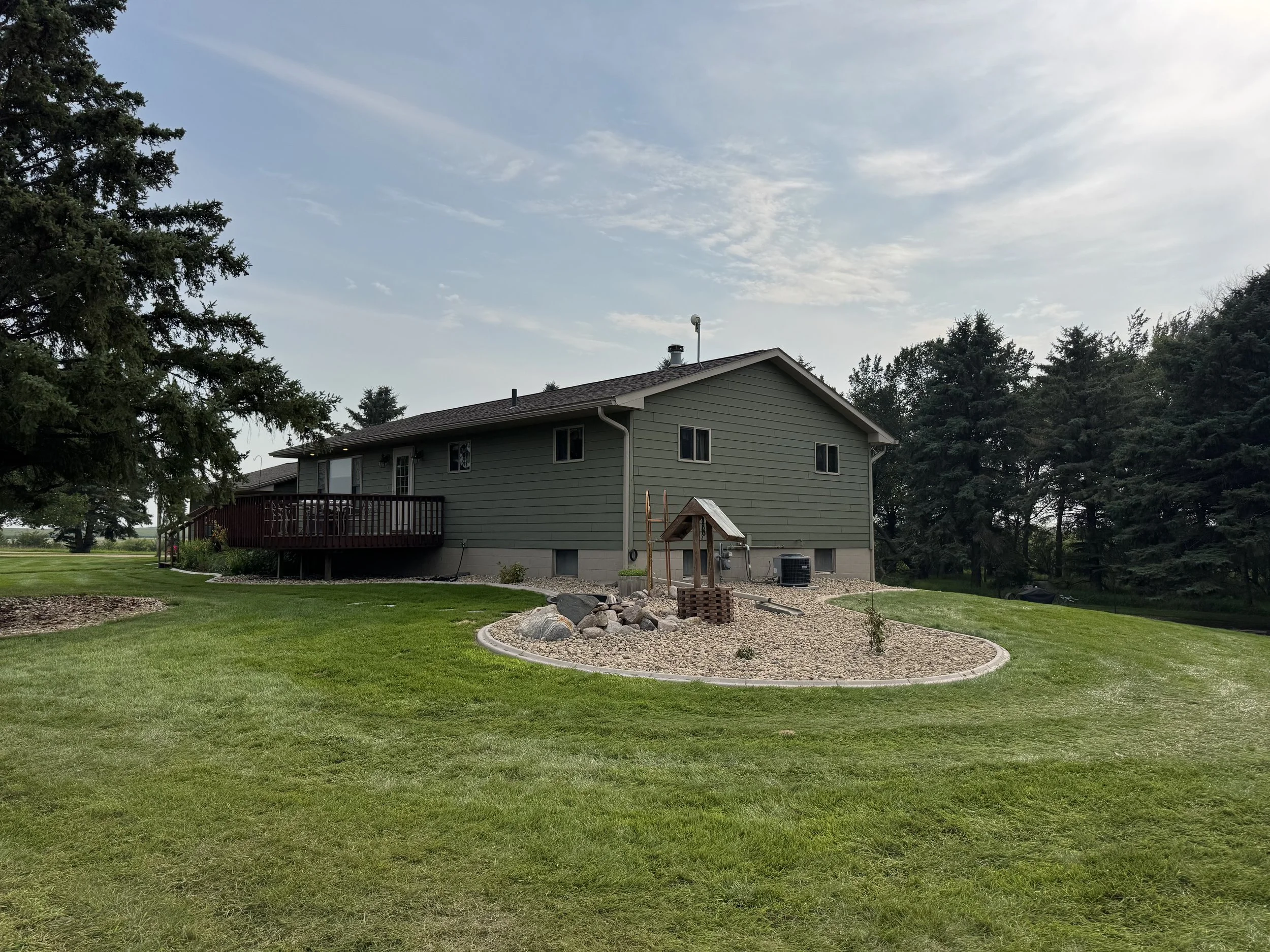 Backyard landscaping project in Watertown, SD with decorative rock, edging, and focal features creating a clean, modern outdoor space.