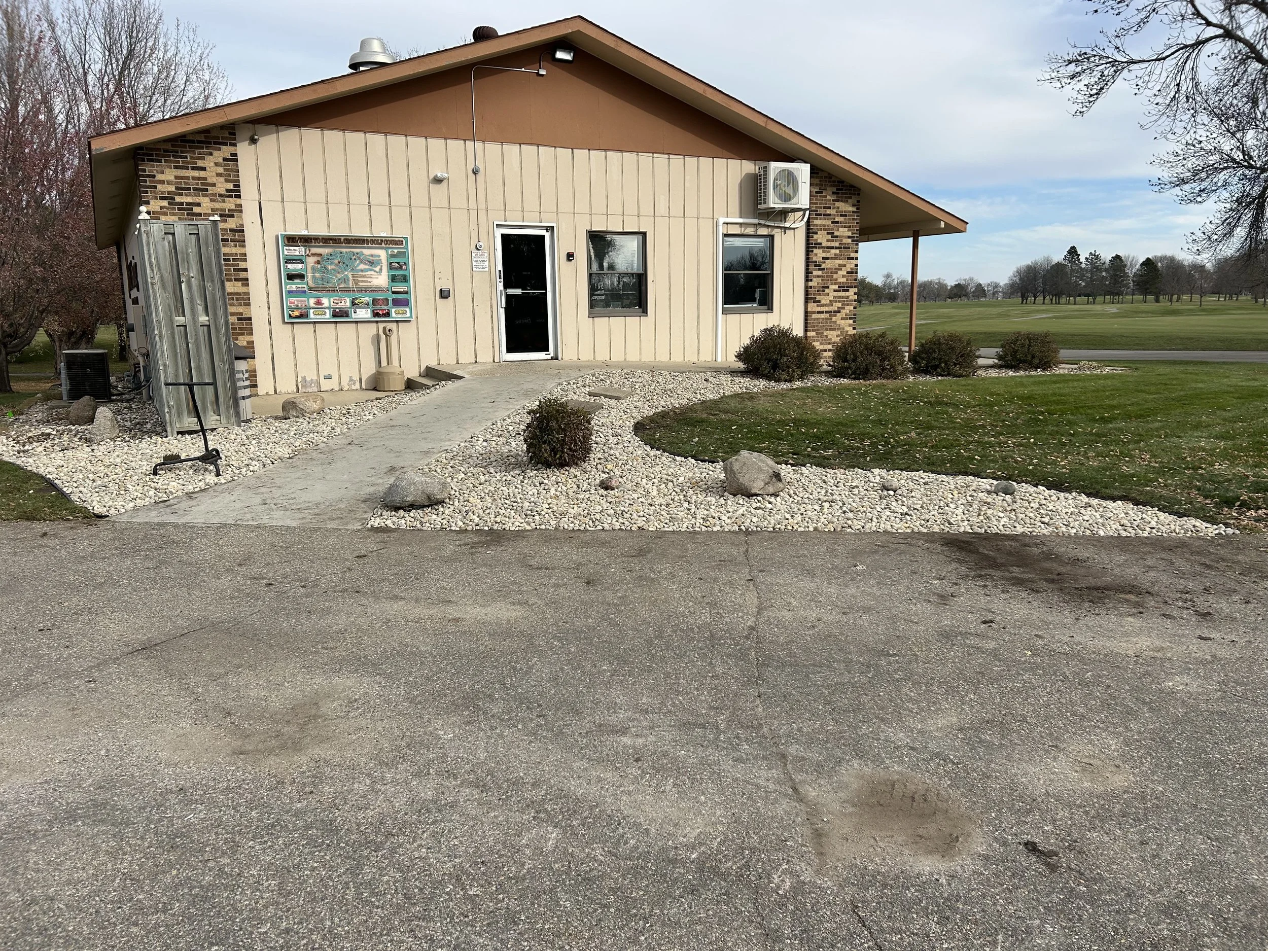 Commercial landscape installation in Watertown, SD featuring decorative rock, edging, and shrub placement for a clean, professional appearance.