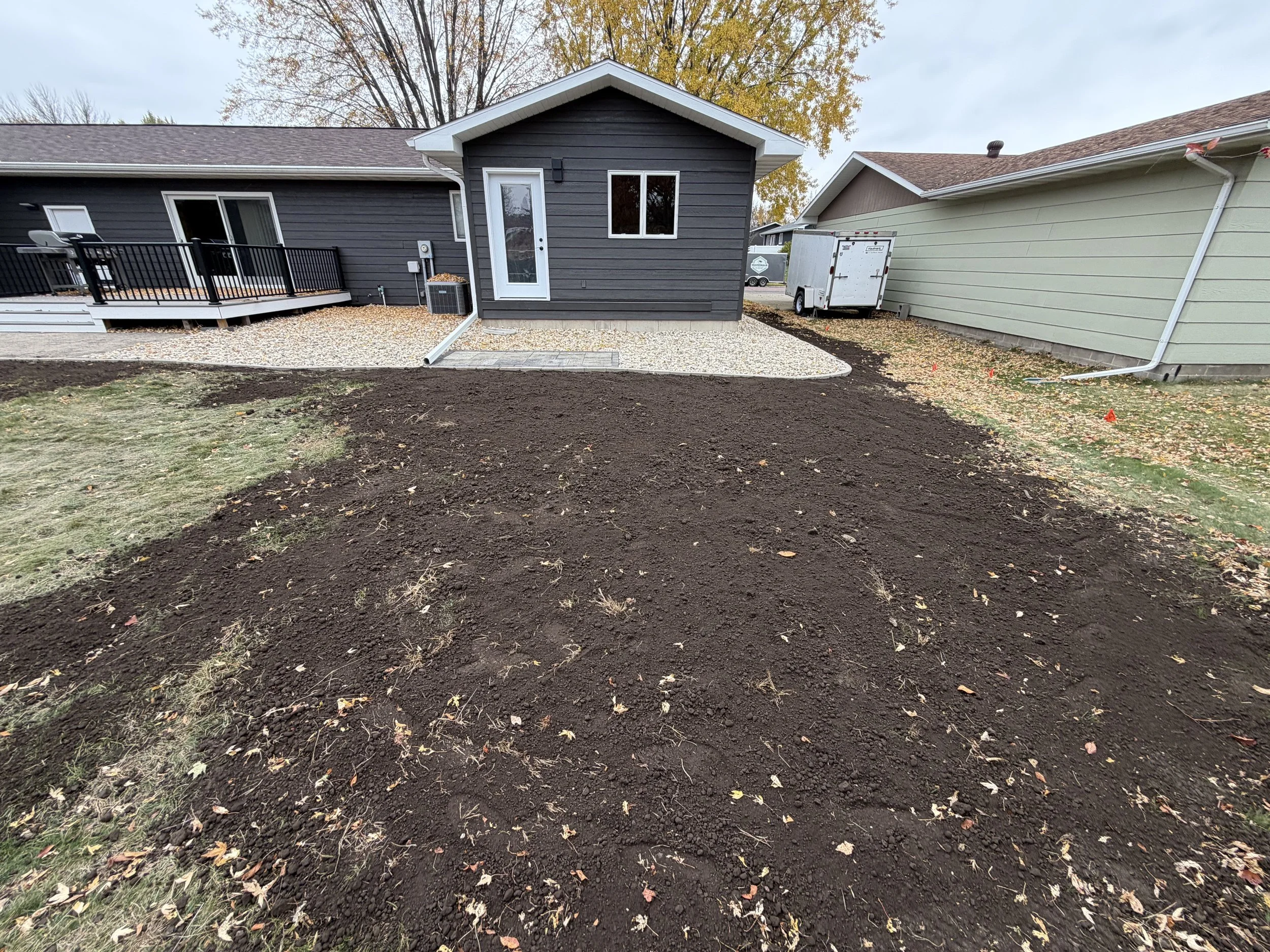 Completed landscape installation in Watertown, SD featuring fresh rock, clean edging, and a newly graded lawn area. This transformation creates a clean, low-maintenance, and visually appealing outdoor space.