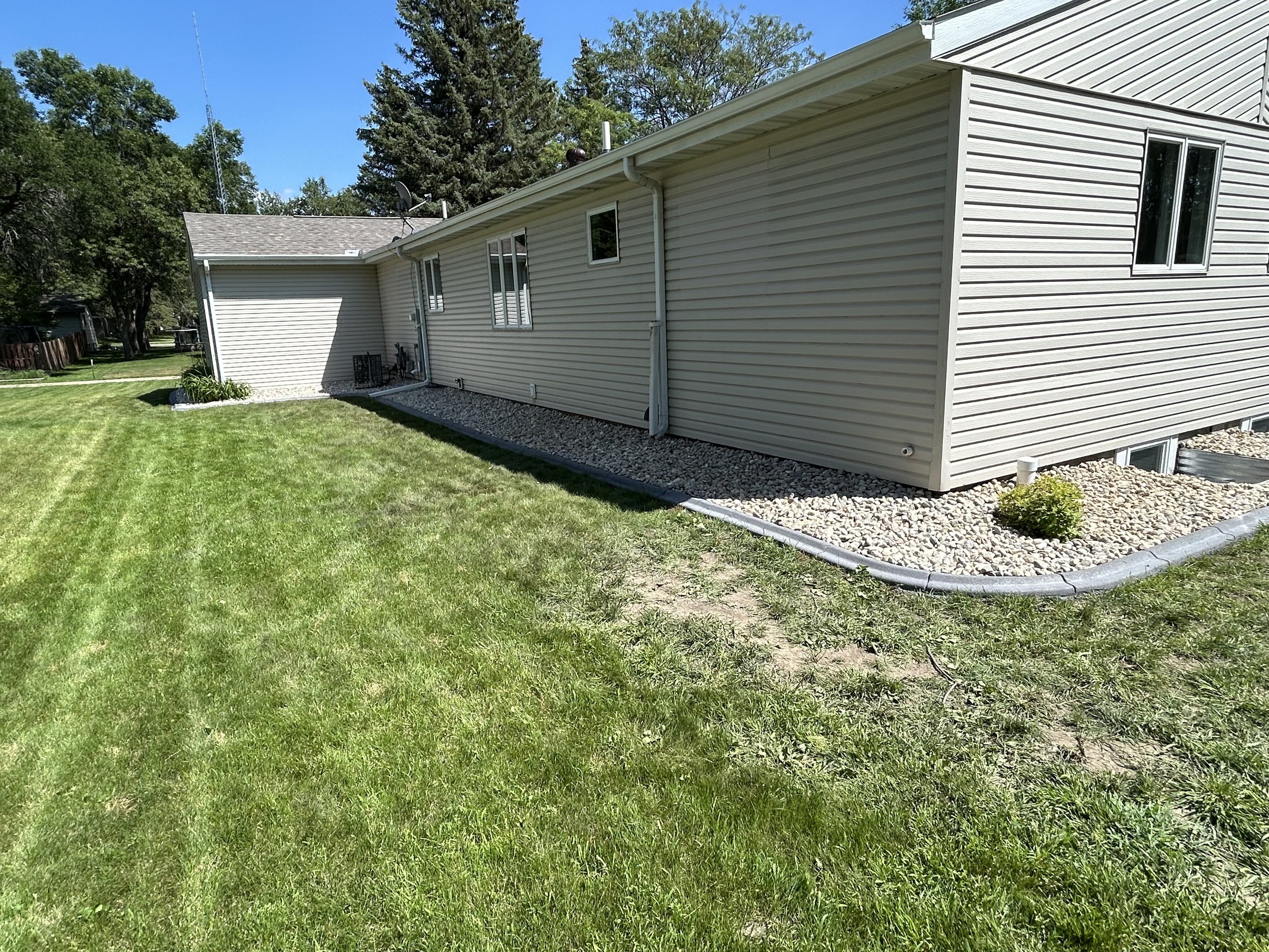 Completed landscape installation in Watertown, SD featuring new rock, clean edging, and defined landscape beds along the home. This upgrade improves curb appeal and creates a clean, low-maintenance outdoor space.