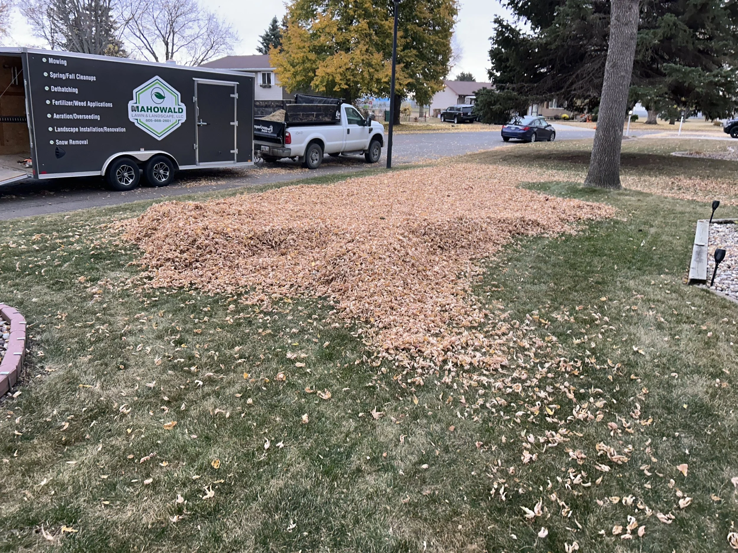 Fall leaf removal services in Watertown, SD with collected leaves ready for hauling and disposal.