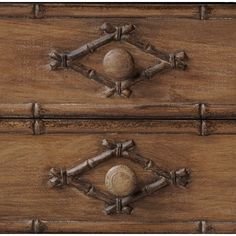 Decorative wooden cabinet with carved drawers featuring round wooden knobs.