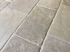 Close-up of a stone or tile floor with grout lines.