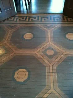 Decorative wooden floor with geometric patterns and inlaid design.