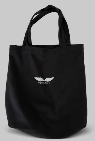 Black tote bag with the Angels Before Us wing logo