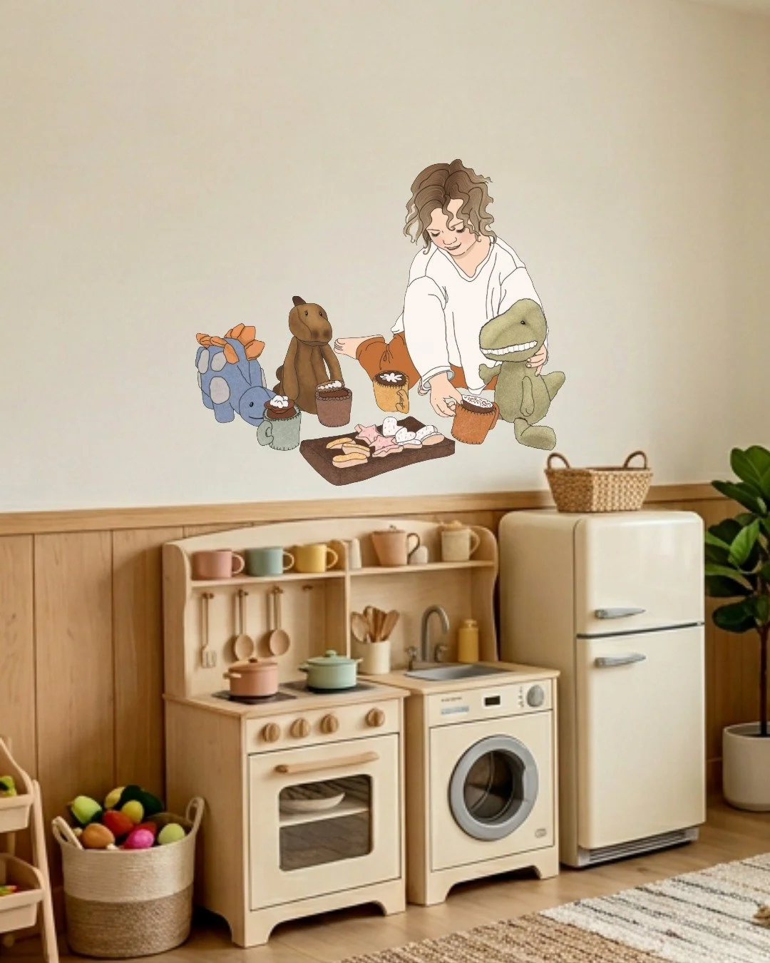 Decorative wall art of a girl with curly hair arranging stuffed animals and muffins, placed above a small kiddie kitchen set and toy basket in a cozy playroom.