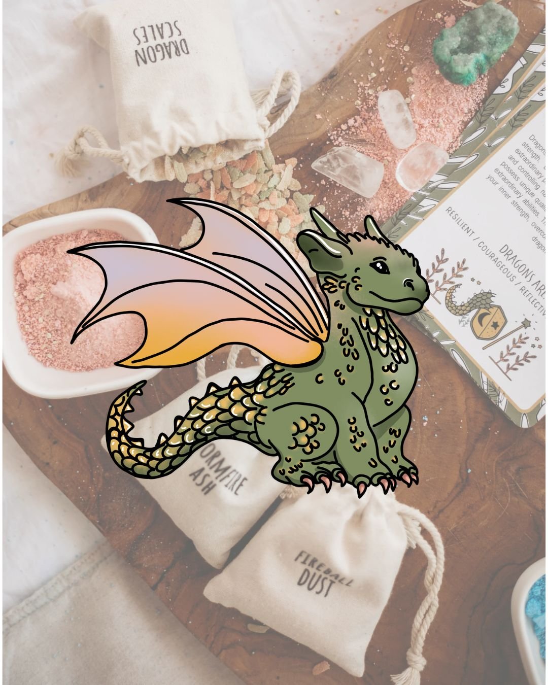 Colorful dragon illustration overlaying a table with crystals, bath salts, and information cards in a whimsical setting.