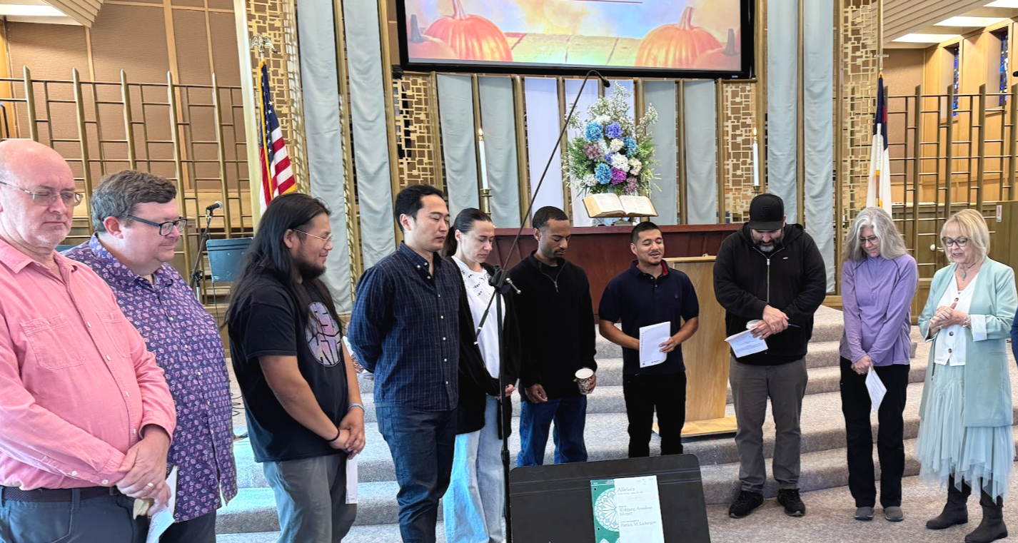men and women gather in a circle for pre-service prayer at first presbyterian church Mountain View