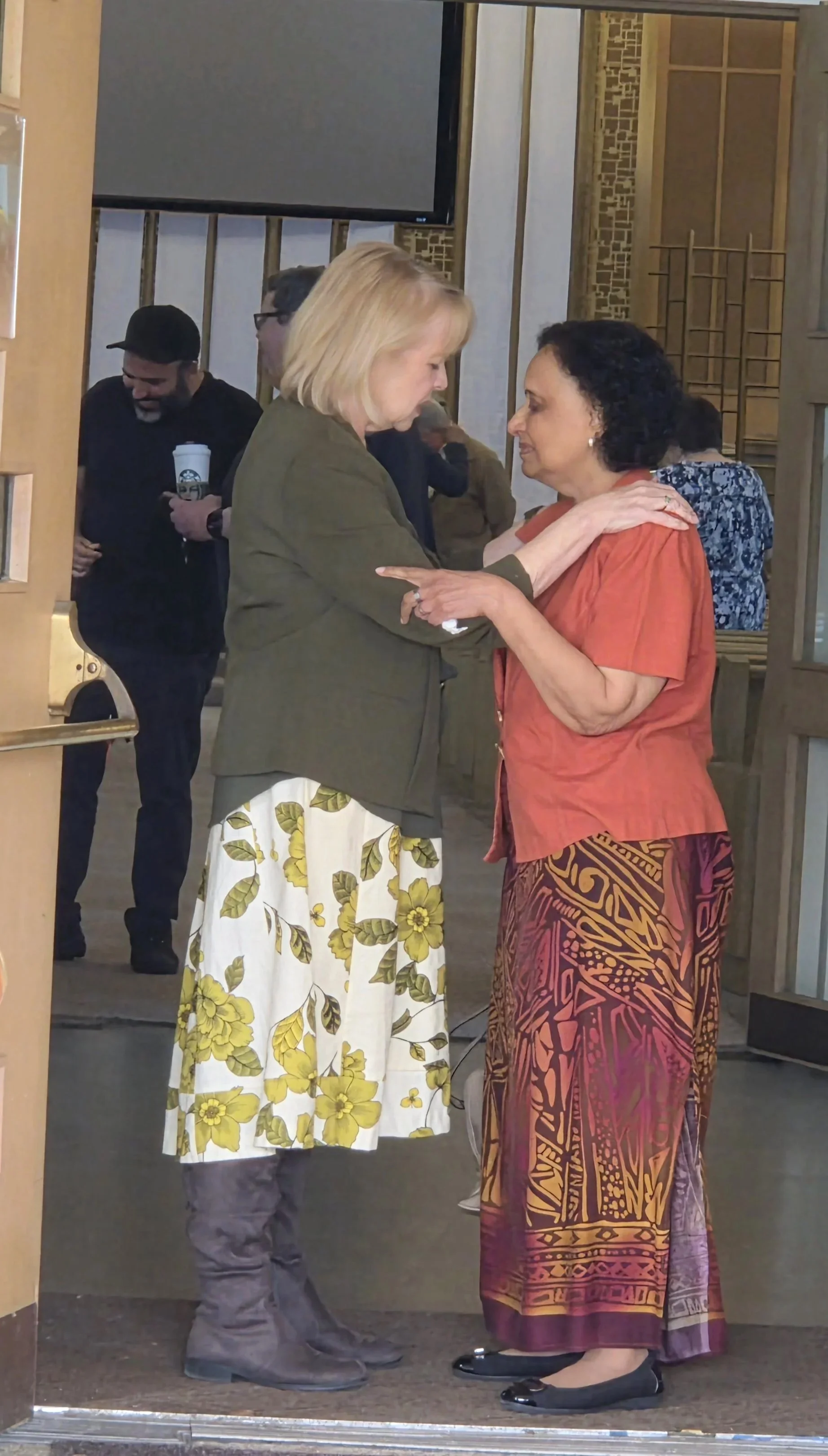 Pastor Kim and a congregant in prayer before a Sunday worship service