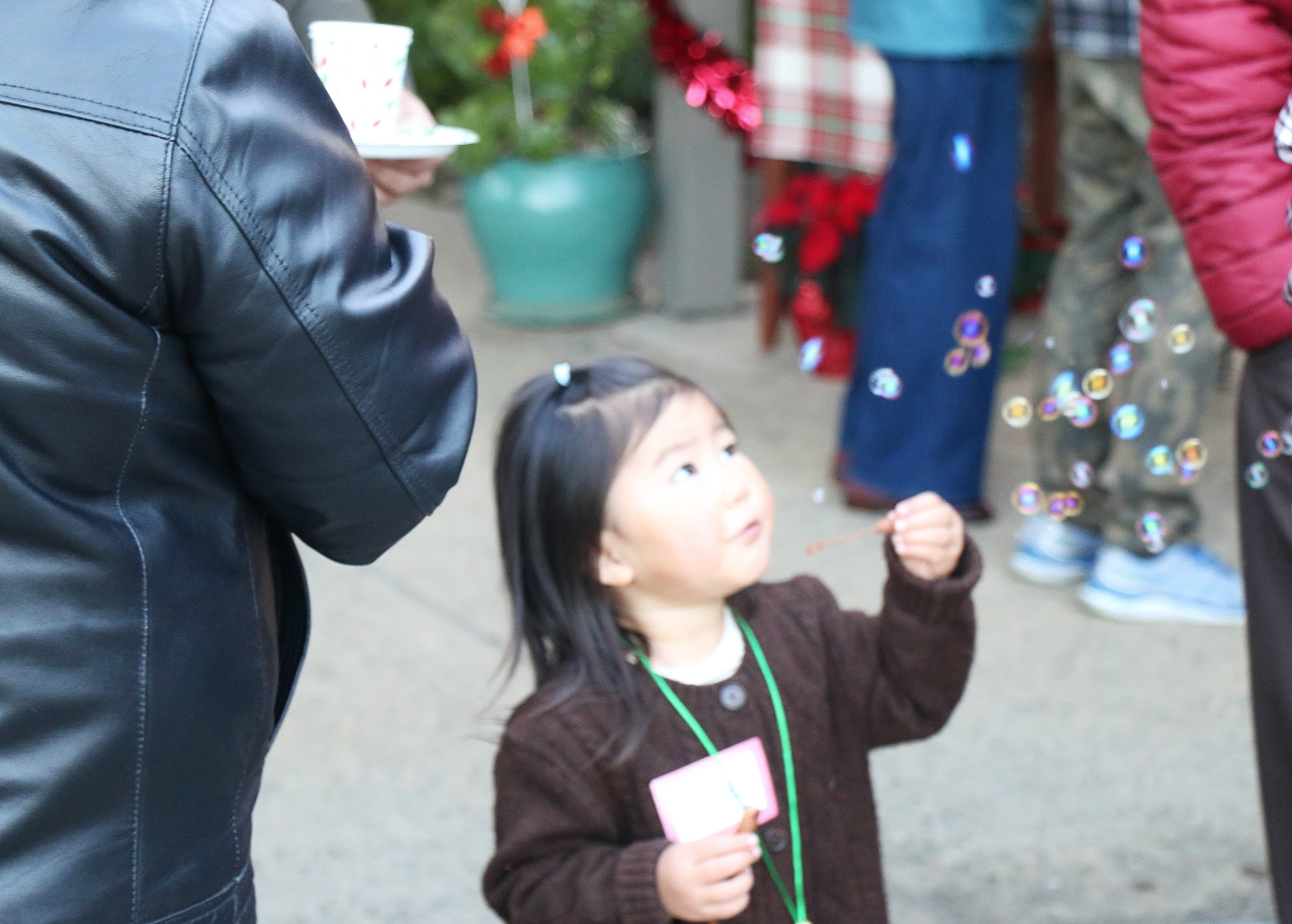 a little girl blows bubbles at a christmas part at fpcmv