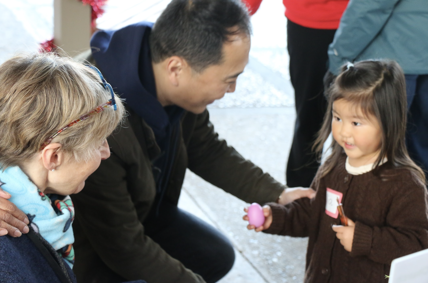 Multi-generational gathering at church Christmas party with children