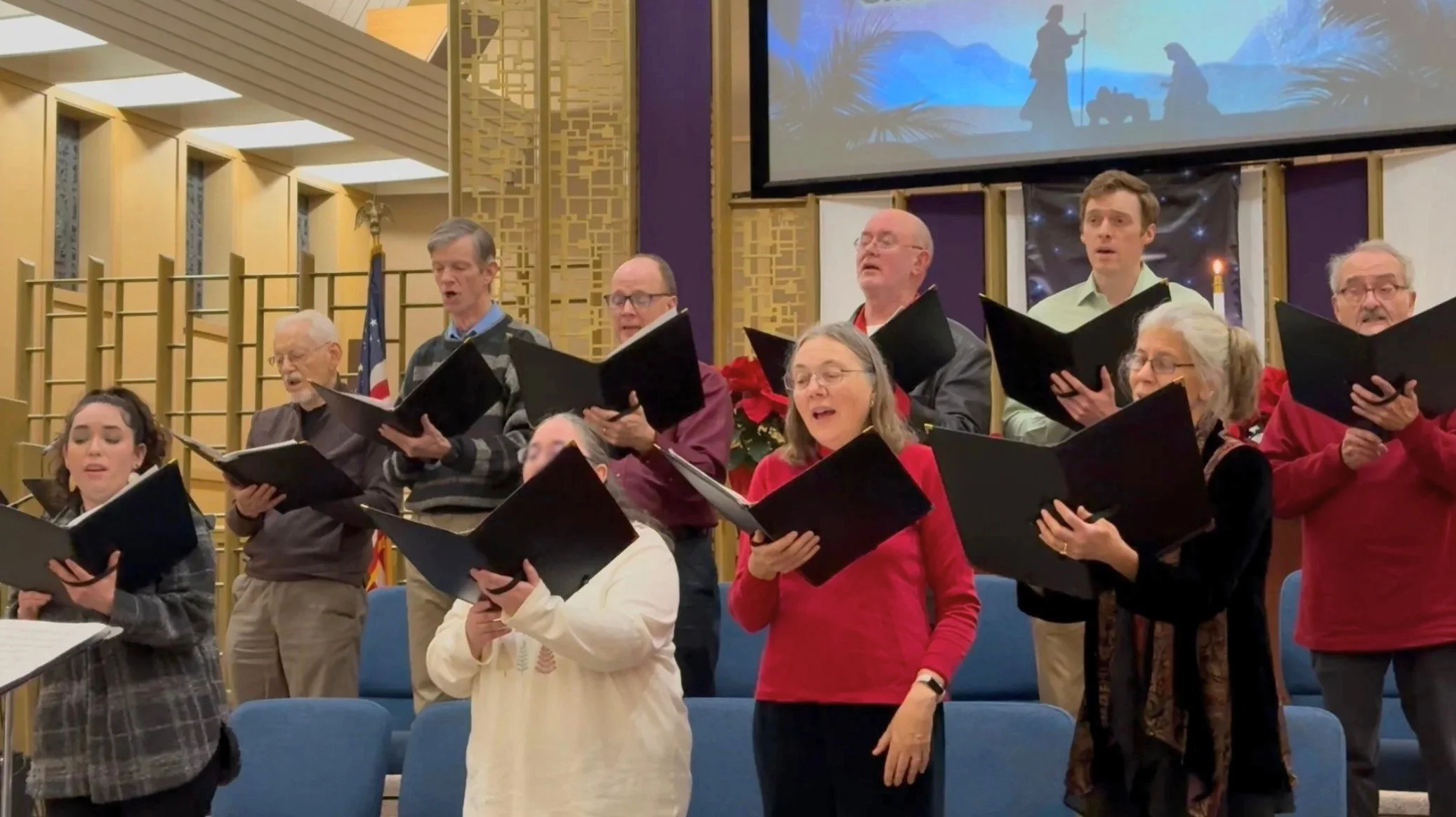 men and women gather to sing in the fpcmv choir during our Christmas Eve service in the sanctuary