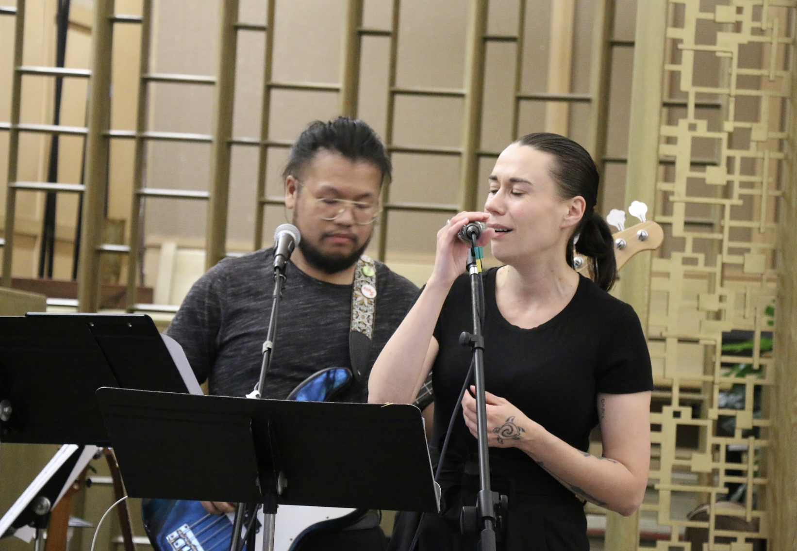 members of the worship team singing and playing guitar during Sunday service