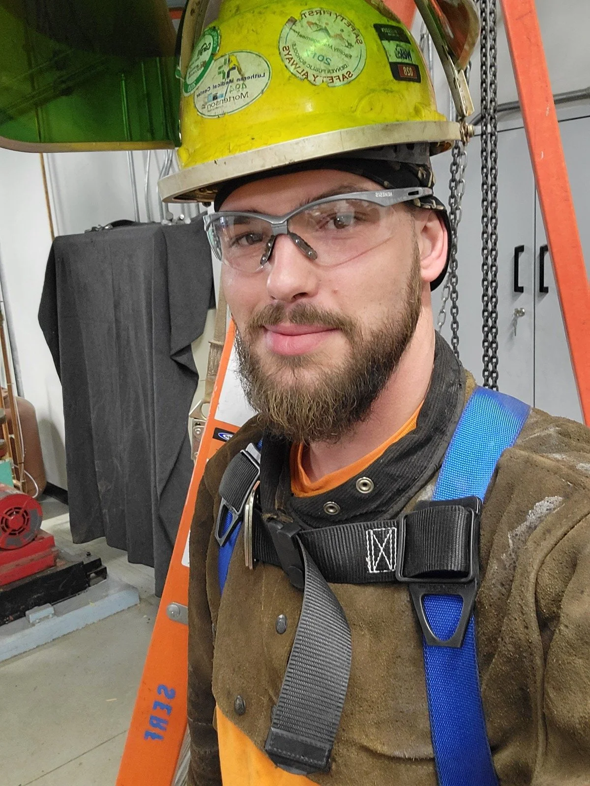 Gadge Bell owner of Boiler and Chiller Killers LLC wearing safety harness and hard hat at commercial demolition job site Colorado