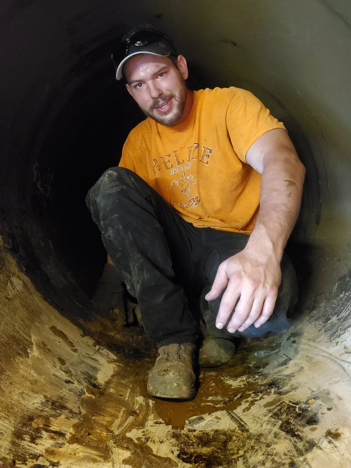 Boiler and Chiller Killers owner Gadge Bell working inside confined space during HVAC demolition project Denver Colorado