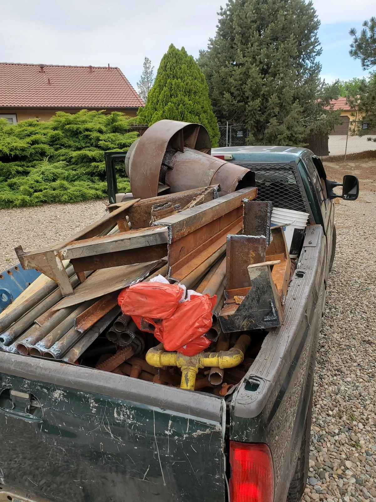 Demolished boiler sections loaded on truck for scrap hauling after residential boiler removal Denver Colorado