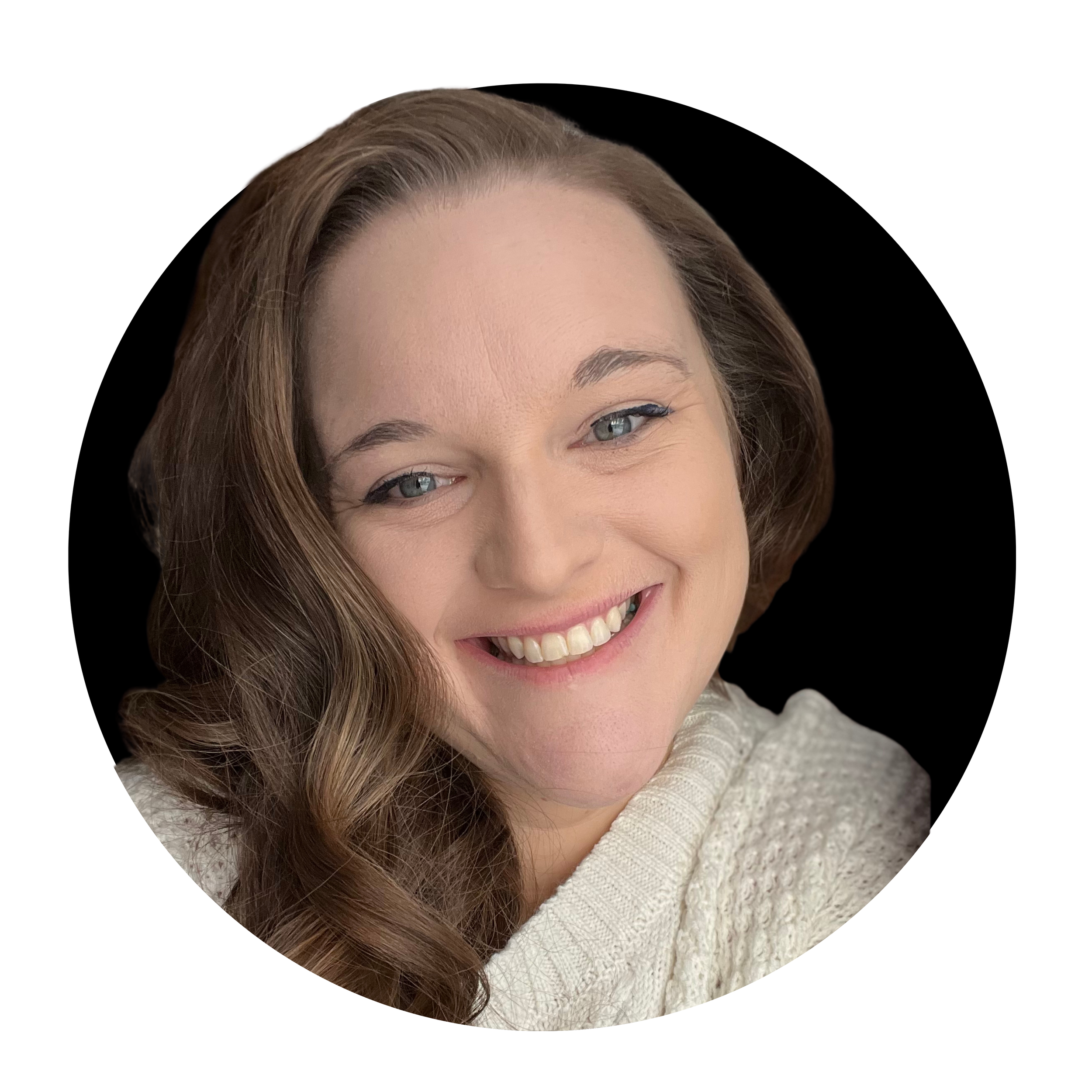 A woman with light skin, long wavy brown hair, and blue eyes smiling in a close-up portrait against a black background. She is wearing a white textured sweater.