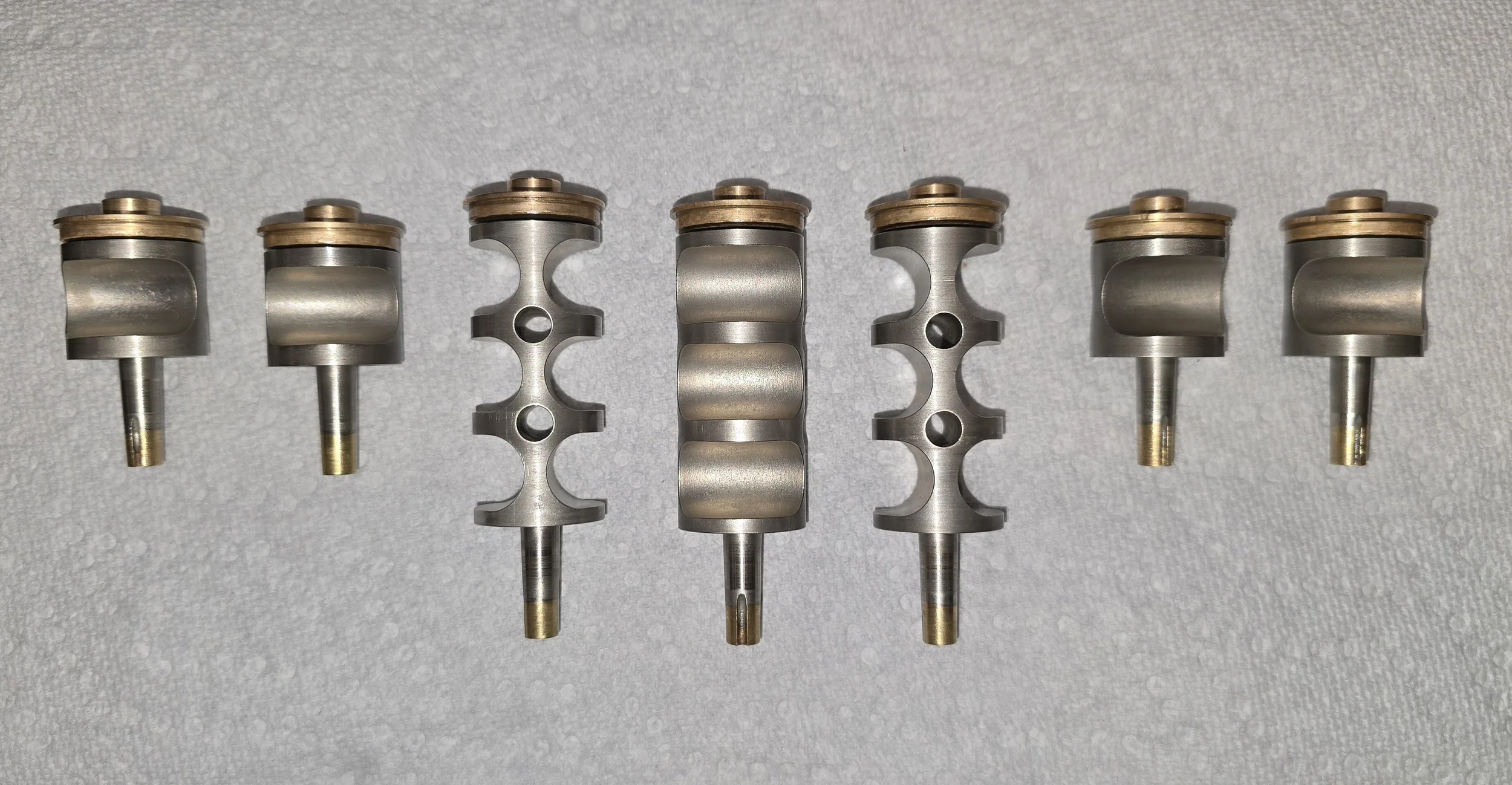 A set of seven Schmid rotary valves for a triple French horn, disassembled and nickel plated during rebuild at Reddick Hornworks.