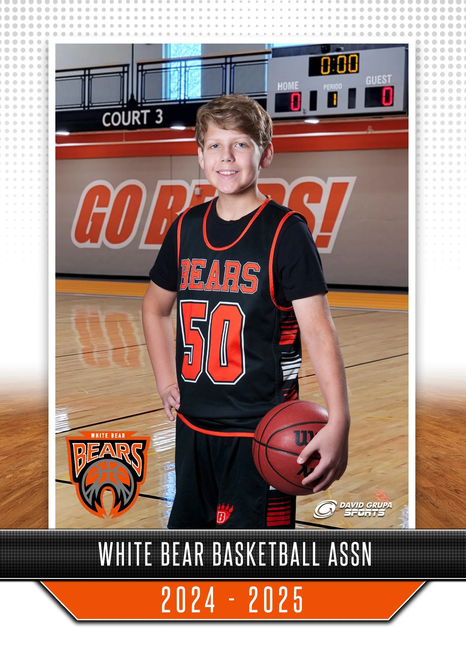 A young boy in a Black and orange basketball uniform holding a basketball in a gymnasium. The background shows a score scoreboard and a large sign that reads 'GO BEARS!' indicating a school team. The image promotes the White Bear basketball team for 