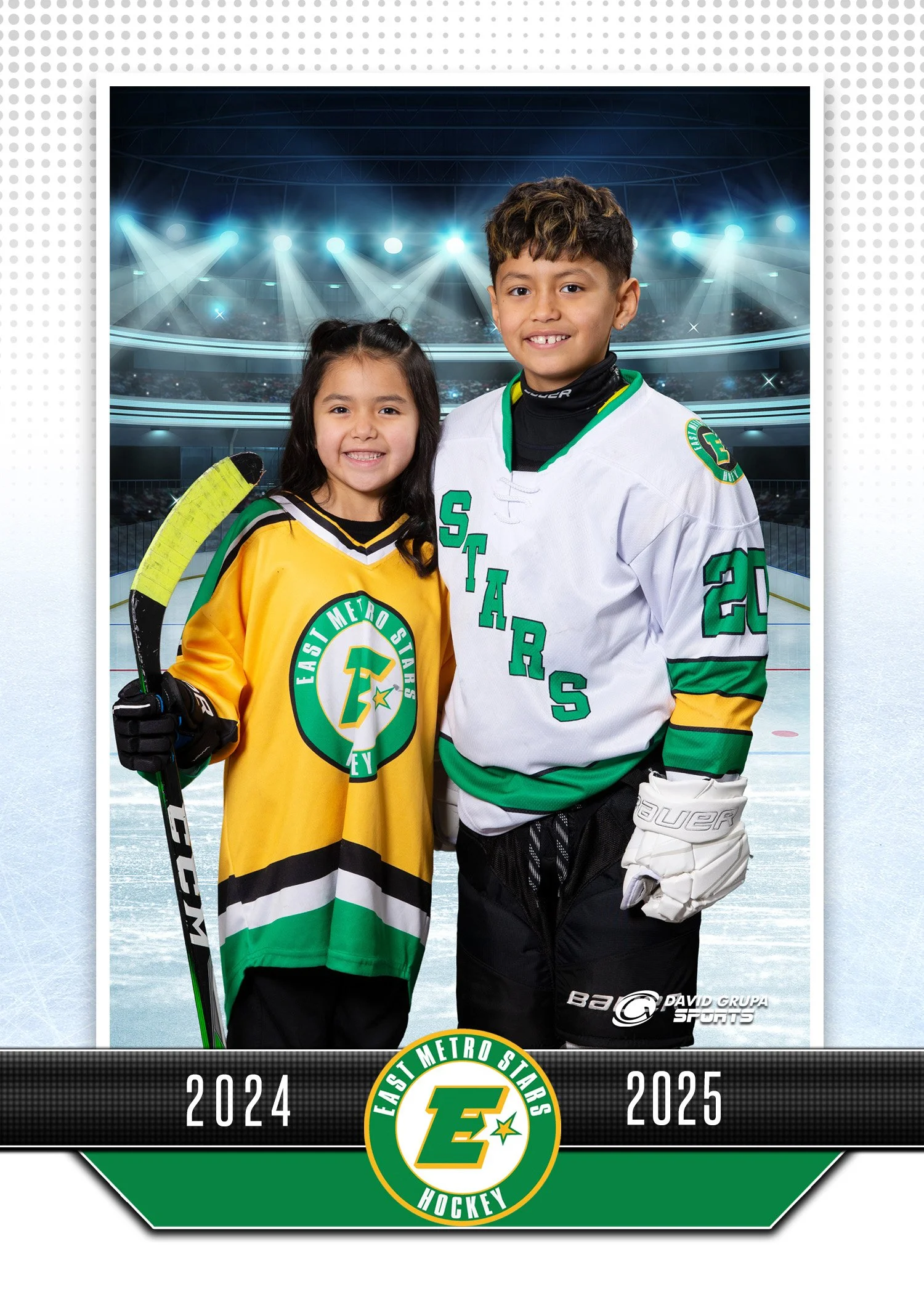 Two kids in hockey jerseys, a girl in yellow and a boy in white, standing on an ice rink in an arena with bright lights. The girl is holding a hockey stick. The image has a border with the text "2024" and "2025", and a logo that says "East Metro Star