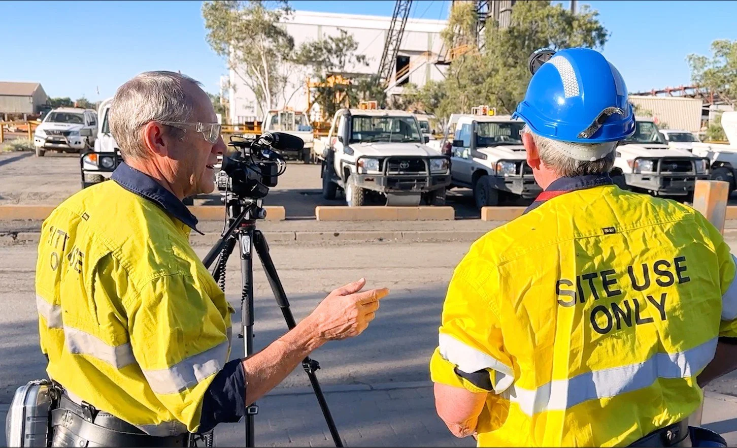 Cliff Wilson filming on-site mining training video with colleague.