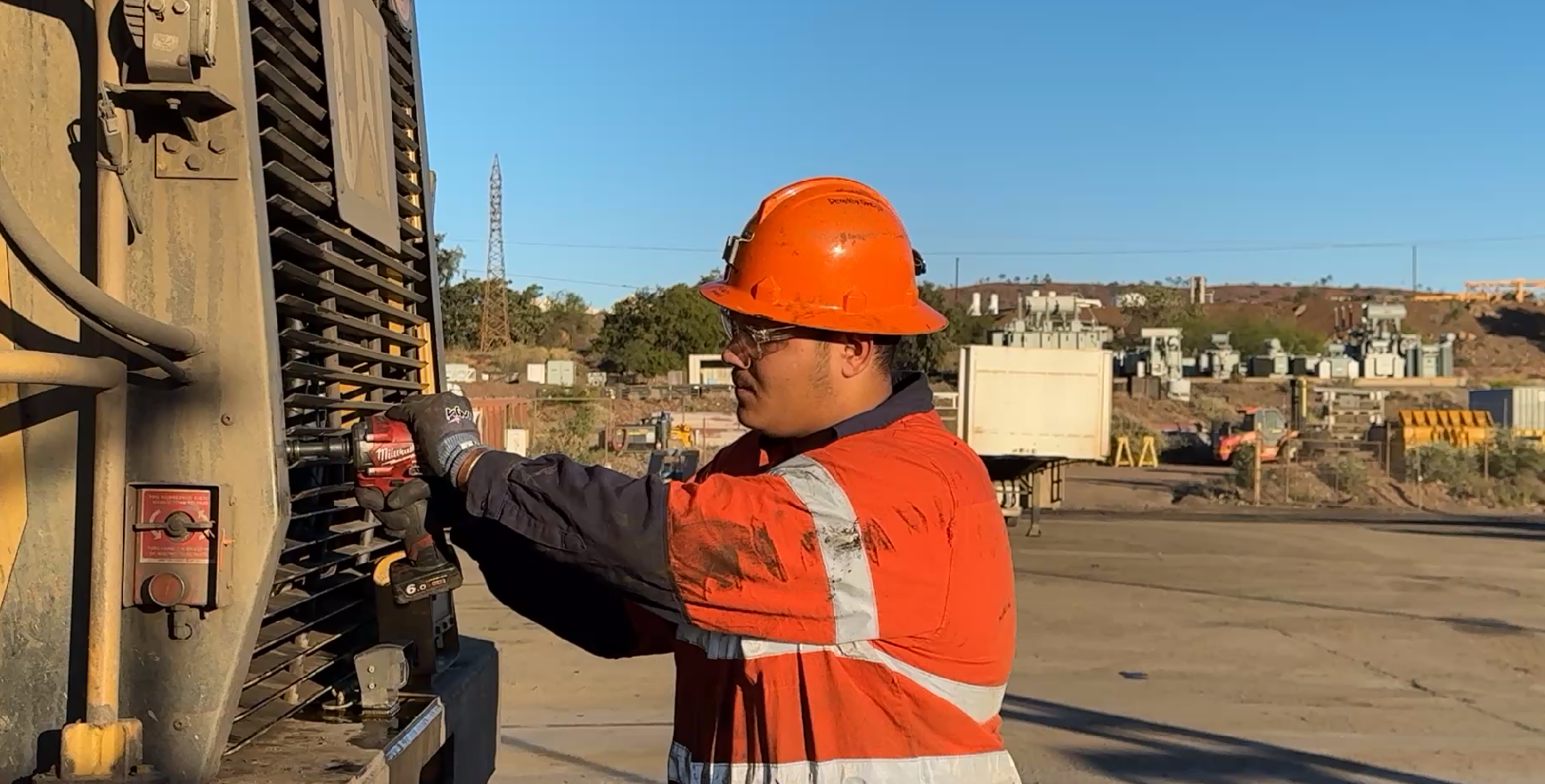 Apprentice diesel fitter working on mining loader for training and video presentation project.