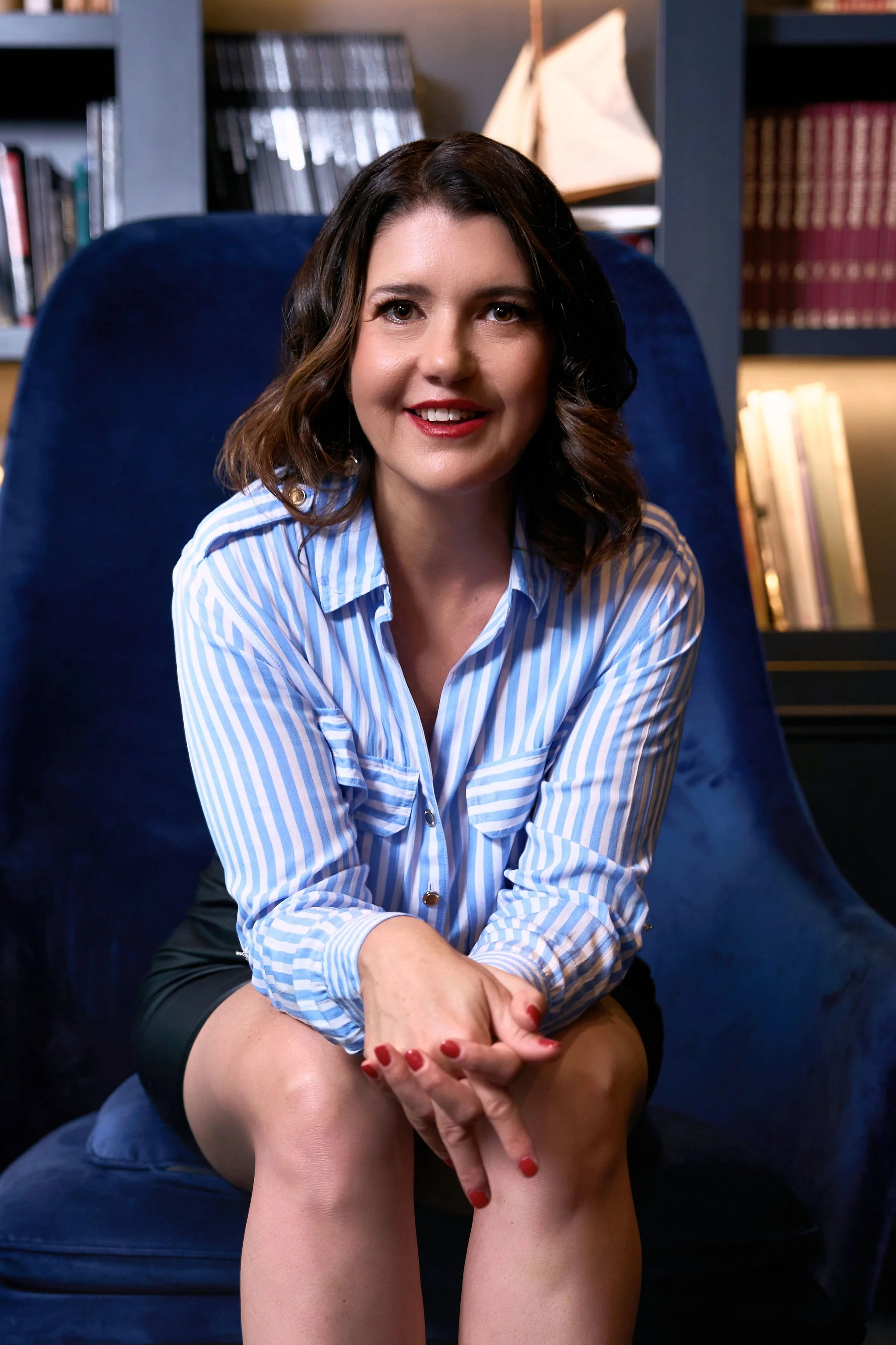 Sabine Lehner executive coach Sydney seated in blue velvet chair smiling