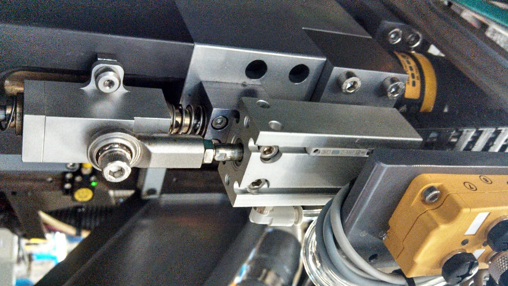 Close-up of mechanical components including metal parts, springs, and wires.