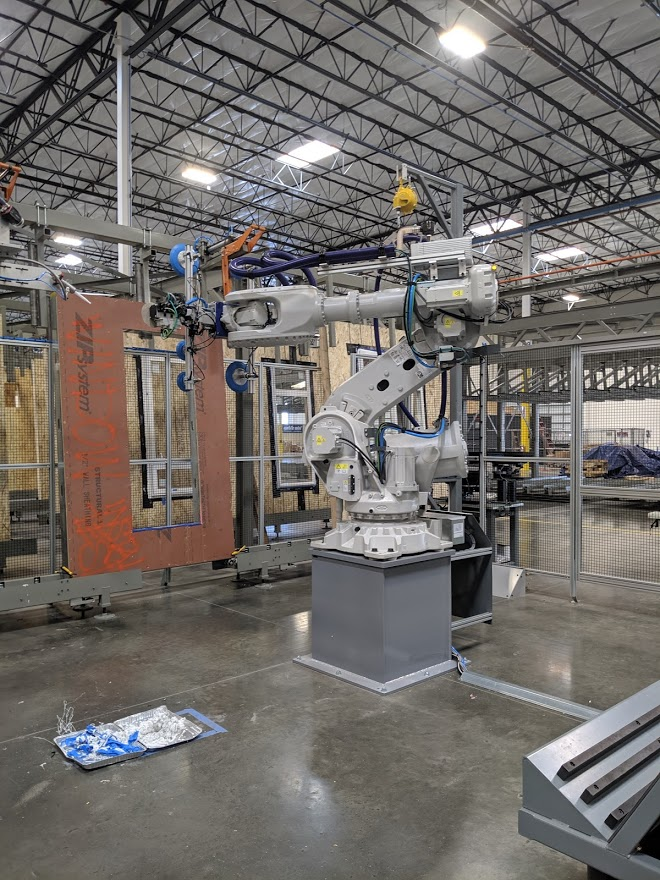 Industrial robotic arm in a manufacturing facility.