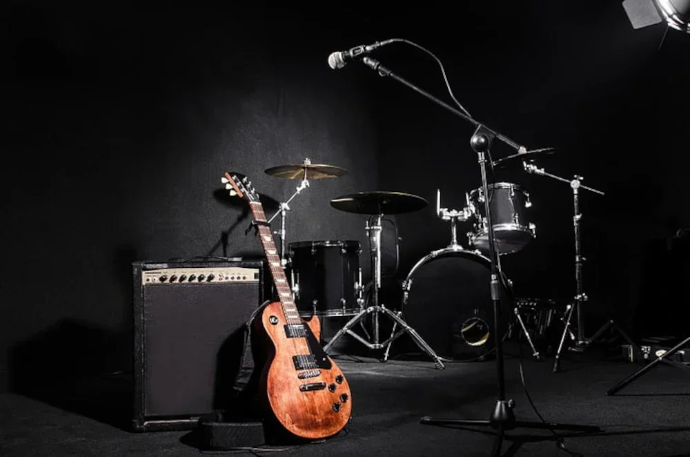 A guitar, guitar amp, and drums.