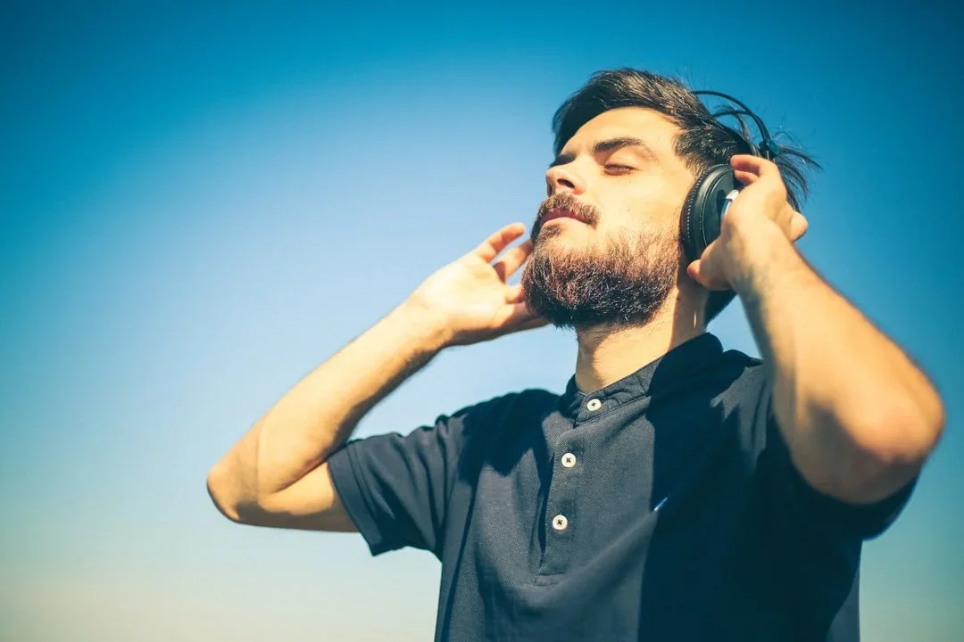 Person enjoying professionally mixed and mastered music on headphones