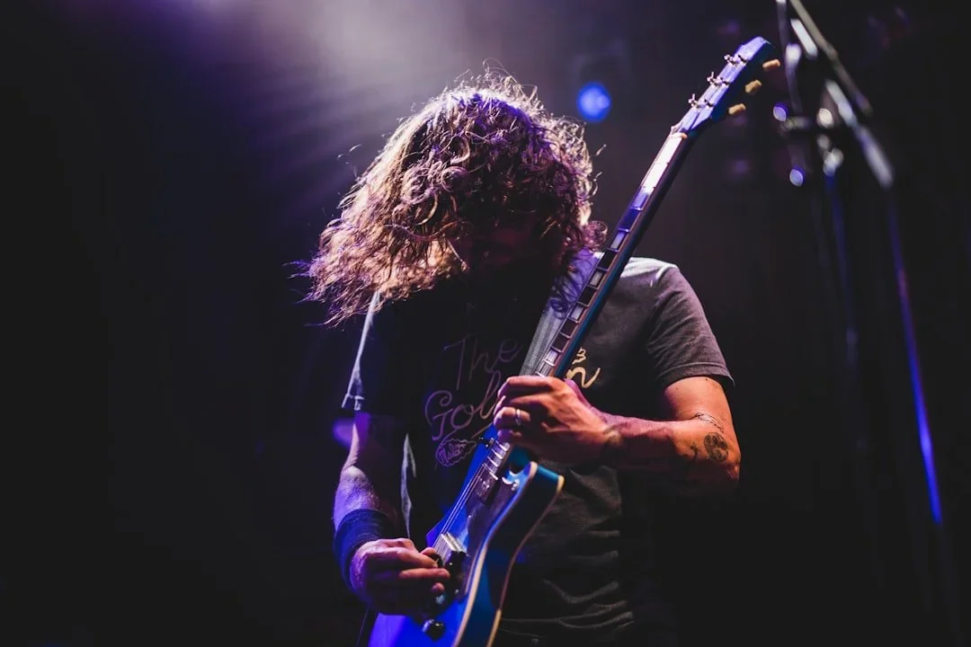 Rock musician playing guitar at a live show
