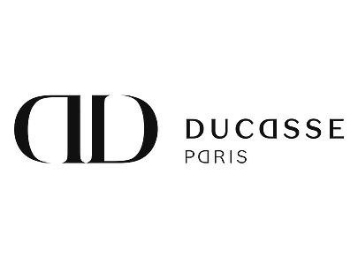 Ducasse Paris logo with a stylized 'D' symbol and the text 'Ducasse Paris' underneath. Hyperlocal World of Travel.