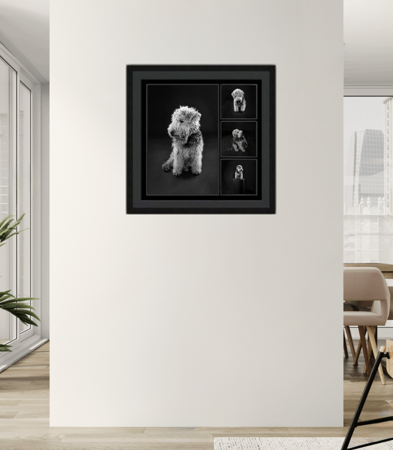 A framed black and white photograph of a fluffy dog in various poses hanging on a white wall in a modern living space.