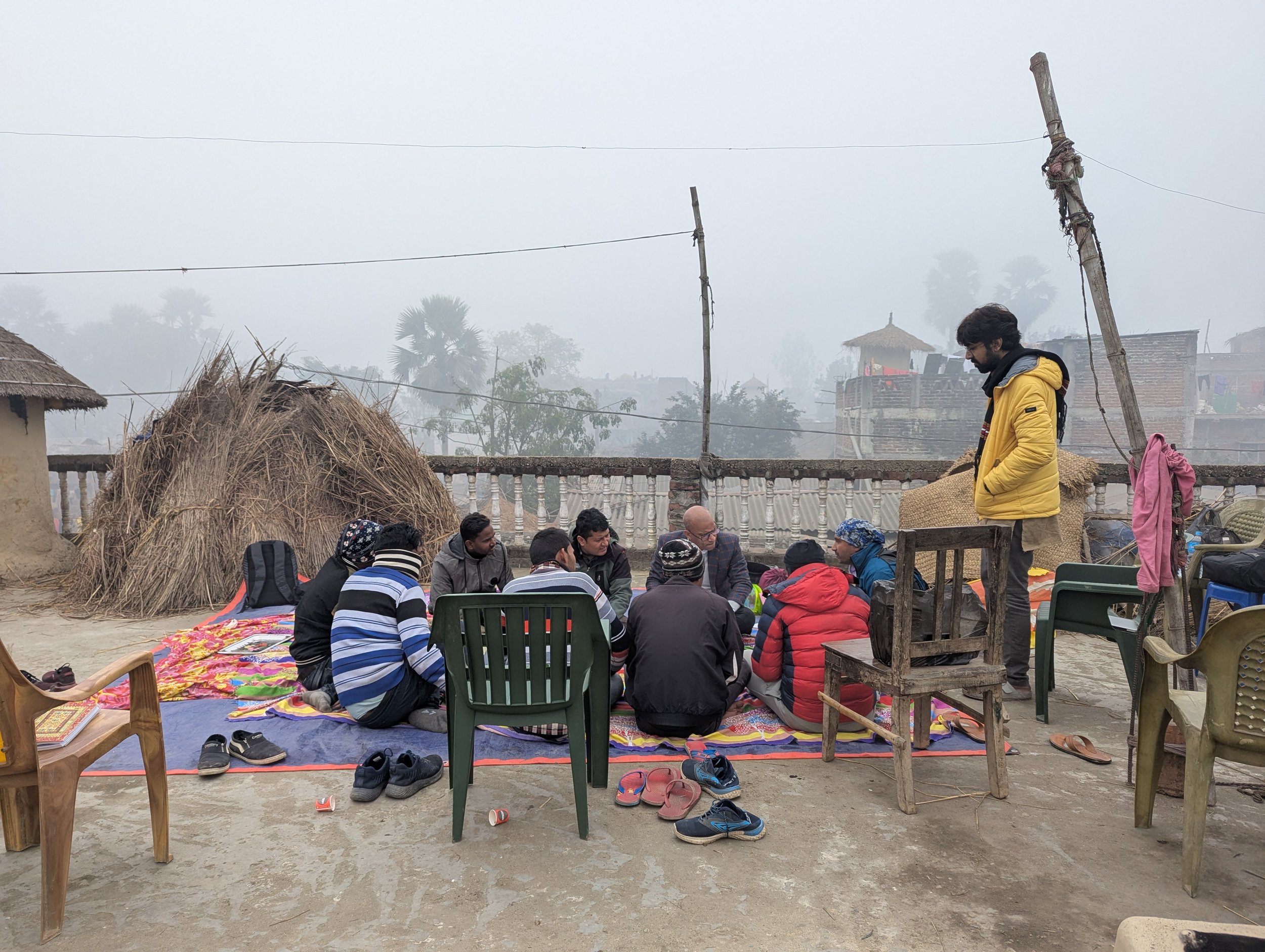 Participatory research session with community members seated outdoors on a rooftop in the Terai region of Nepal, during field research on gendered nutrition norms conducted by Lagori Collective with Helen Keller International and USAID.