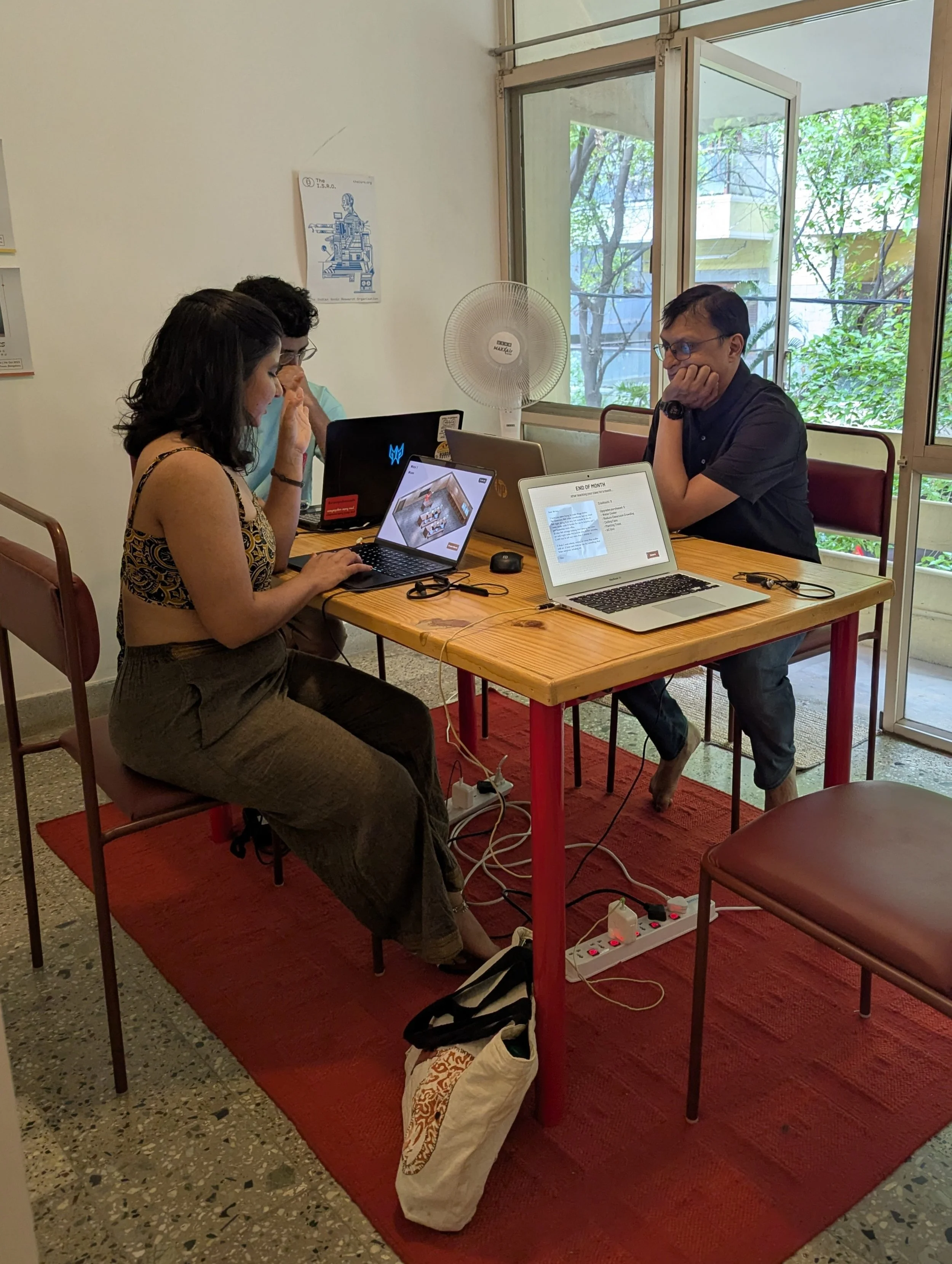 Two participants playing Classroom Crashout, a 2D game prototype on urban heat stress in schools, developed during Heat Futures at 78°E by Lagori Collective and Good Life X with British Council support.